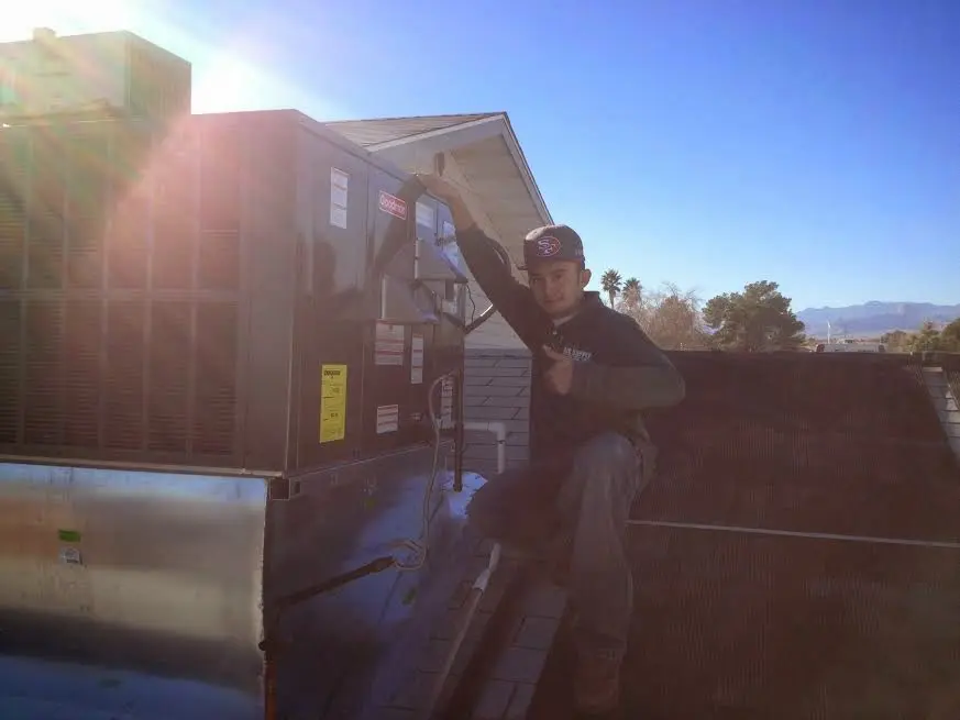 HVAC technician performing Boiler Repair on a rooftop unit in Lake Stickney